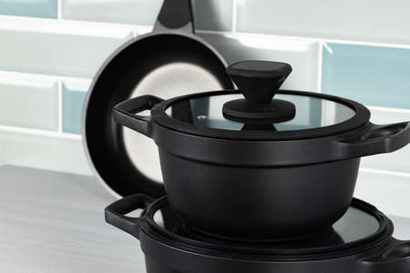 Set of black cookware on kitchen counterの写真素材