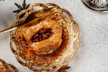 Piece of Turkish baklava in golden arabic plateの写真素材