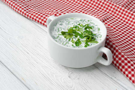 Russian summer cold soup Okroshka on white wooden tableの写真素材