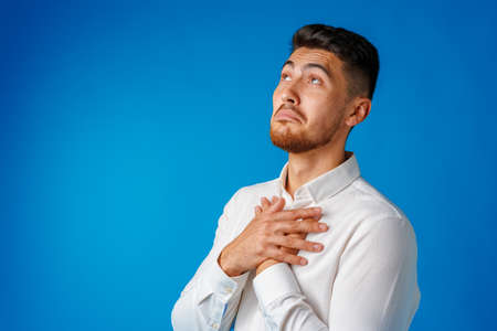 Amazed and confused bearded young man looks with astonishment.の写真素材