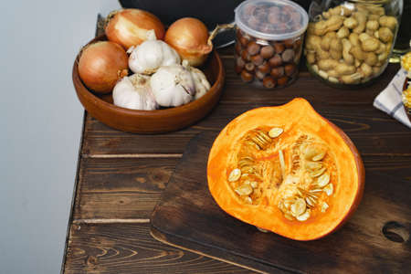 Pumpkin half on wooden board on kitchen table