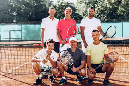 Group of six male tennis players standing on courtの写真素材