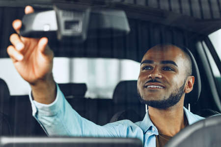 African american male driver sitting in a car