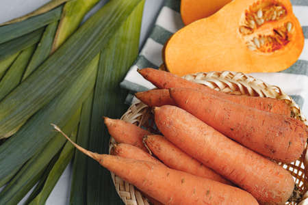 Pumpkin, carrots and leek on kitchen tableの写真素材