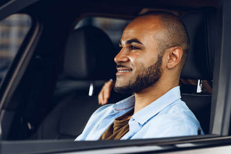 African american male driver sitting in a car