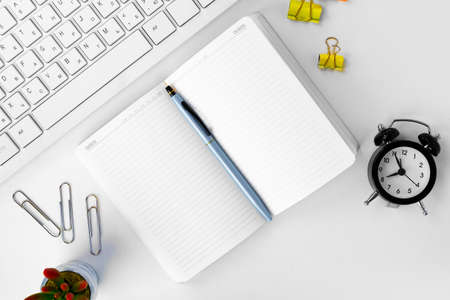 Top view of laptop and notepad on table