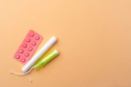 Female medical tampons and painkiller pills top viewの写真素材
