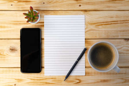 Minimalist workspace with notebook and succulent plant