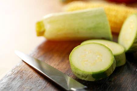 Chopped circles of zucchini on wooden tableの写真素材
