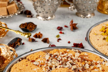 Turkish pastries and scattered dry fruits on table
