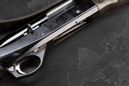 Trigger of a rifle on black background
