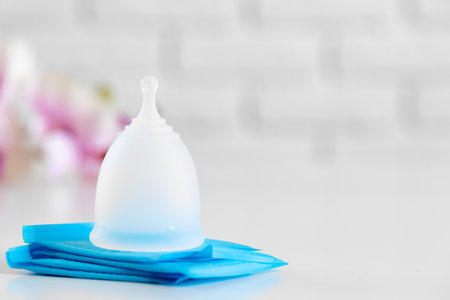 Menstrual cup and hygienic pad on table close upの写真素材