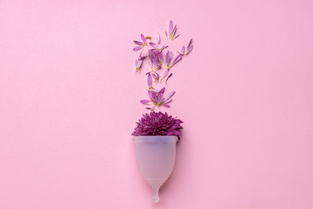 Menstrual cup with flowers on pink backgroundの写真素材