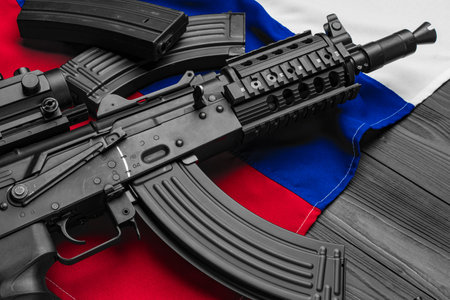 Rifle weapon on flag of Russia close up