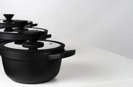 Black cooking pots on grey background front viewの写真素材
