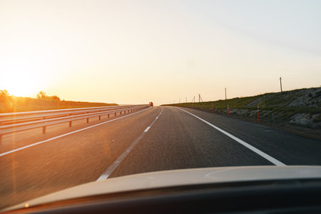 Empty highway at dawn, view from drivers perspective