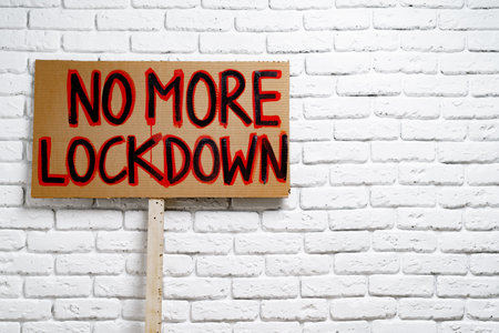 Protestive placard against coronavirus lockdowns against wallの写真素材