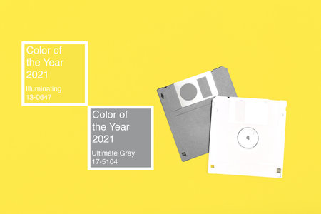 Two gray computer floppy disks on yellowの写真素材