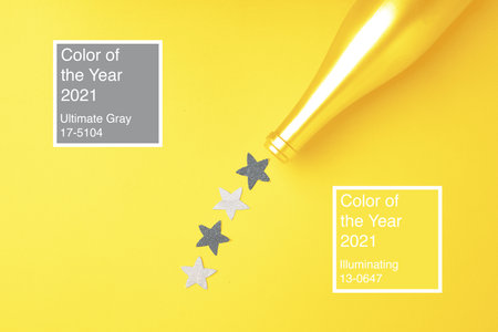 Festive background with champagne bottle and confetti in colors of the year 2021