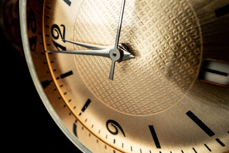 Old metal watch dial in dark macro photo