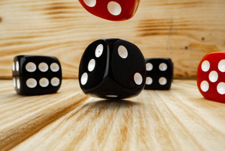 Red and black dice cubes on wooden backgroundの写真素材
