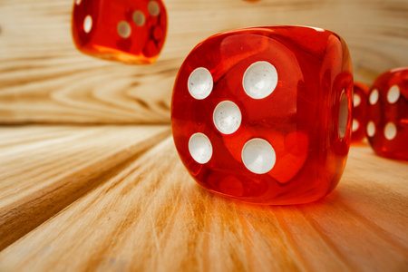 Red dice tossed on wooden background close upの写真素材