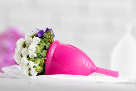 Menstrual cup and flower bud close upの写真素材