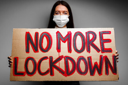 Protestive placard against coronavirus lockdowns against wallの写真素材