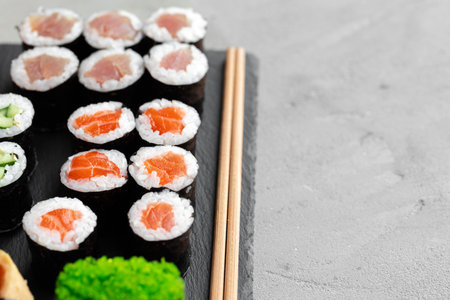 Maki sushi set served on black stone trayの写真素材