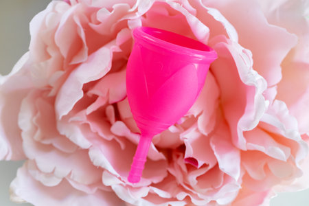 Menstrual cup and flower bud close upの写真素材
