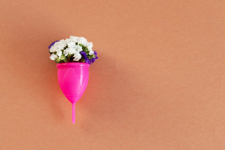 Menstrual cup and flower bud close upの写真素材