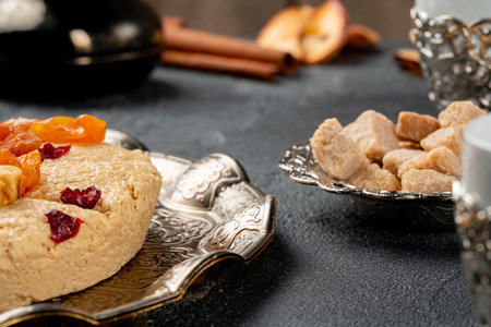 Halva with dried fruits on arabic dishwareの写真素材