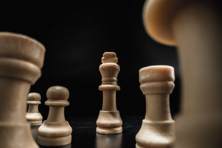 Chess game with chess pieces against black background