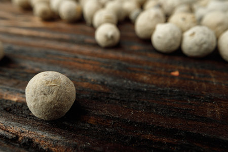White peppercorn spice heap on wooden tableの写真素材