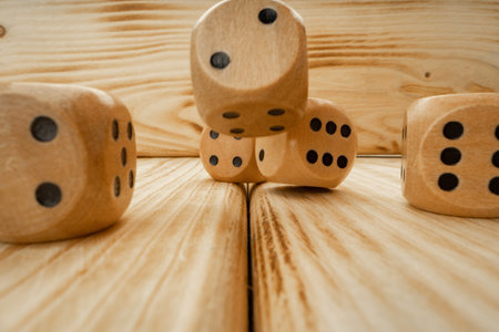 Wooden dice tossed on wooden background close upの写真素材