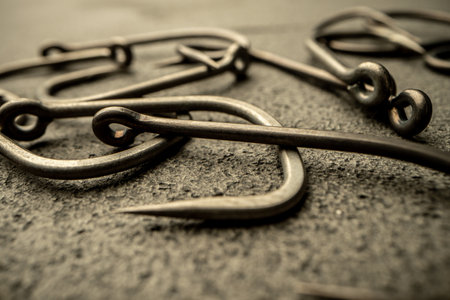 Fishing hooks on concrete textured background macro