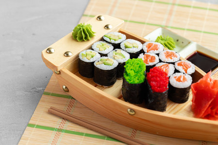 Set of maki sushi on wooden boat trayの写真素材