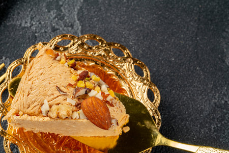 Piece of halva dessert on golden spatulaの写真素材