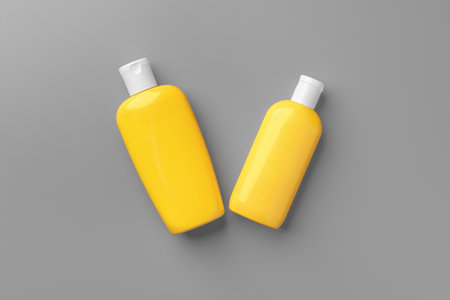 Yellow cosmetic container on gray background top viewの写真素材