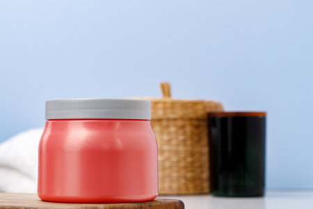 Pink skincare product jar against blue backgroundの写真素材