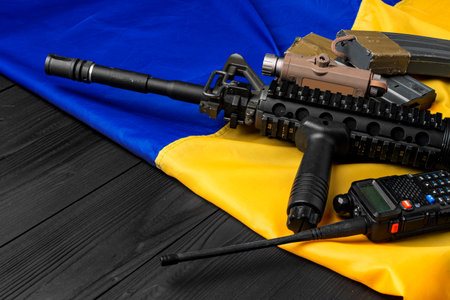 Rifle and walkie-talkie on flag of Ukraine