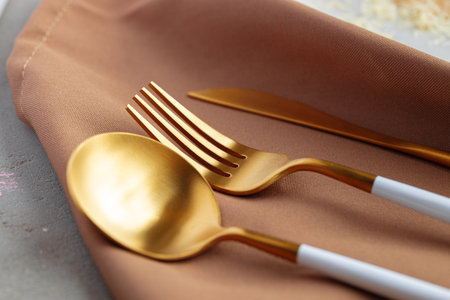 Set of golden cutlery on napkin close upの写真素材