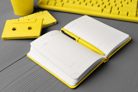 Yellow notepad on gray wooden background top view
