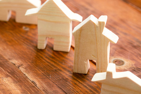 Wooden house miniature on wooden surface close upの写真素材