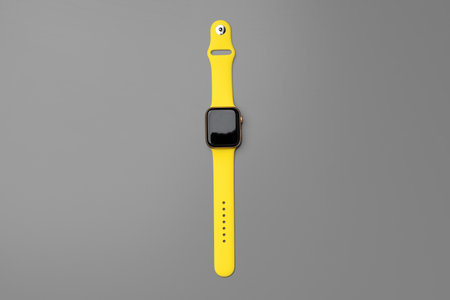 Yellow smartwatch on gray background close upの写真素材