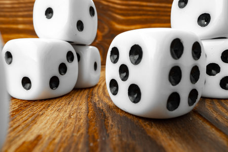 Close up of white dice on wooden background