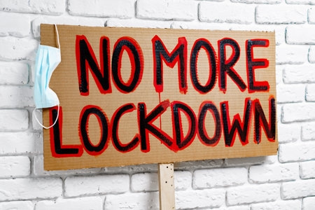 Protestive placard against coronavirus lockdowns against wallの写真素材