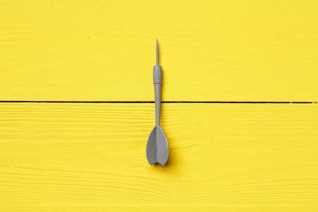 Gray dart arrow on yellow background copy spaceの写真素材