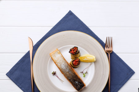 Roasted salmon fillet in plate on white wooden table