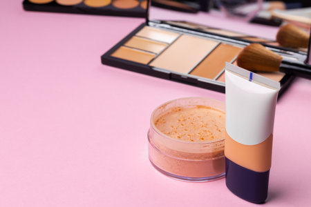 Complexion make up products and brush on pink backgroundの写真素材